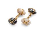 a pair of black, white and gold earrings on a white background