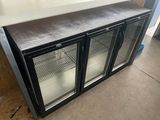 an image of a glass door refrigerator in a room