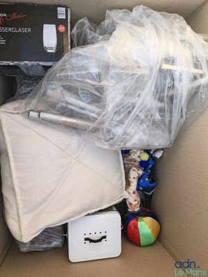 a cardboard box filled with toys and other items