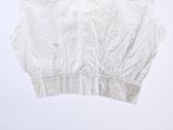 the cropped top is white and has black trims