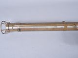 a gold colored pen with a metal handle on a white surface