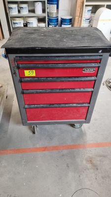 a red tool box sitting on top of a metal cart