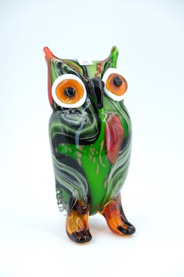 brightly colored glass owl figurine on a white background