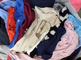 a suitcase full of clothes that is sitting on the floor