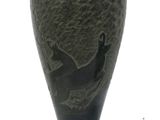 a black vase with a picture of a bird on it