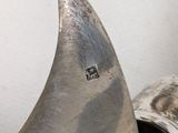 a silver plate with a knife on top of it