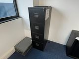a black filing cabinet in the corner of a room