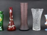 four different vases sitting next to each other on a table
