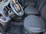 the interior of a car with the door open and the driver ' s seat down