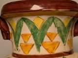 a large vase with flowers painted on it on display