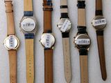 several different types of watches are lined up on a white surface