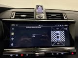 the interior of a car with a touch screen in the center of it