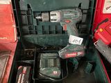 a cordless drill in a tool box with other tools in it