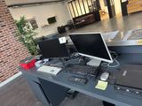 a desk with two computers and a laptop on it