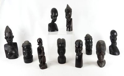 a lot of statues that are sitting on a white surface