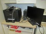two computers and a printer sitting on a desk