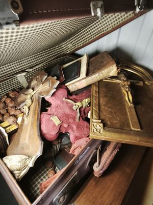 a suitcase full of stuff that is sitting on a table