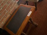 two chairs and a table in a room with a brick wall