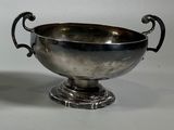 a silver bowl that is sitting on a table