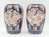 two vases sitting side by side on a white surface