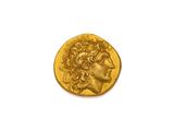 gros plan d'une pièce d'or sur une surface blanche