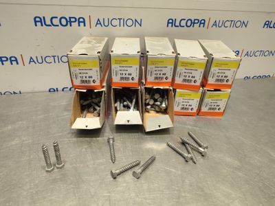 four boxes of screws and a couple of screws on a table