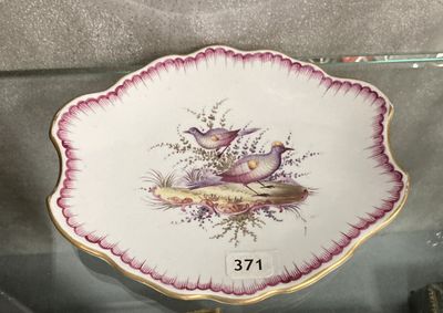 une assiette ornée d'un oiseau, exposée dans une vitrine