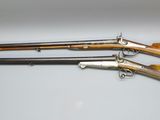 three different types of shotguns on a white surface