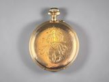 an image of a gold pocket watch with a picture of a man on it
