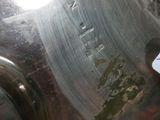 a silver vase with a tag on it sitting on a table