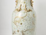 a vase that is sitting on a white surface