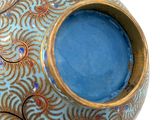a blue and gold vase sitting on top of a table