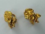 pair of gold tone elephant earrings on a white surface