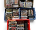 a lot of dvds in a box on the floor