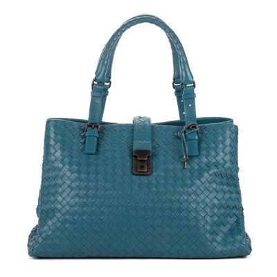 a blue woven leather handbag with a metal buckle