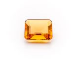 an orange sapphire stone on a white background