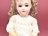 a small doll that is sitting on a red surface
