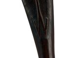 wooden sculpture of an elephant ' s foot with a long tail