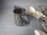 a lot of spoons and spoon rest on a table