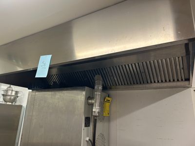 a stainless steel stove top with a ventula above it