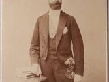 an old photo of a man in a suit and bow tie