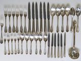a lot of spoons and forks on the table