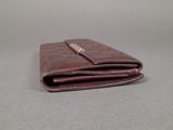 wallet on a table with a white background