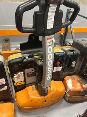 a forklift that is sitting on a table in a warehouse