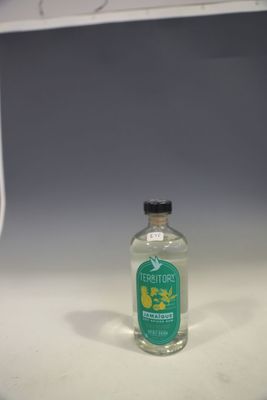 a bottle of alcohol sitting on a shelf in a room