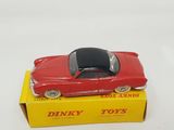 a red toy car sitting on top of a yellow box