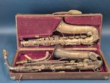 a silver saxophone and a brass instrument in a case