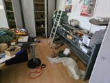 a room with a lot of clutter and tools on the floor