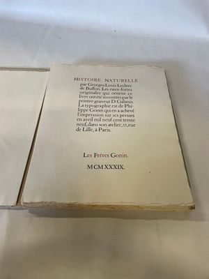 an open book on a table with a white table cloth