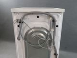 an image of a white dishwasher with a hose attached to it